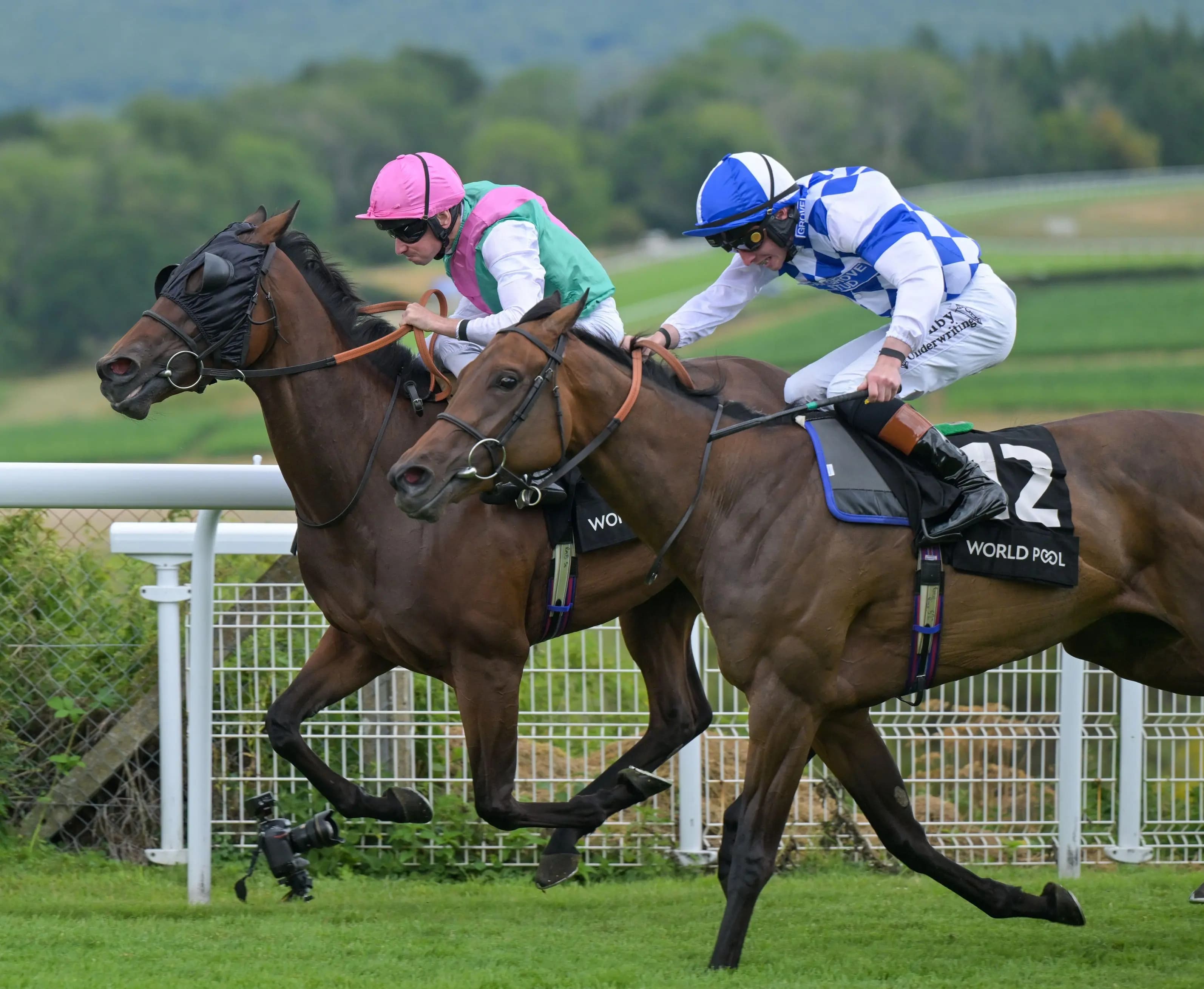 A dead heat between Saqqara Sands, ridden by Rossa Ryan (blue cap), and Tabiti, ridden by Ryan Moore. Pic. Alamy