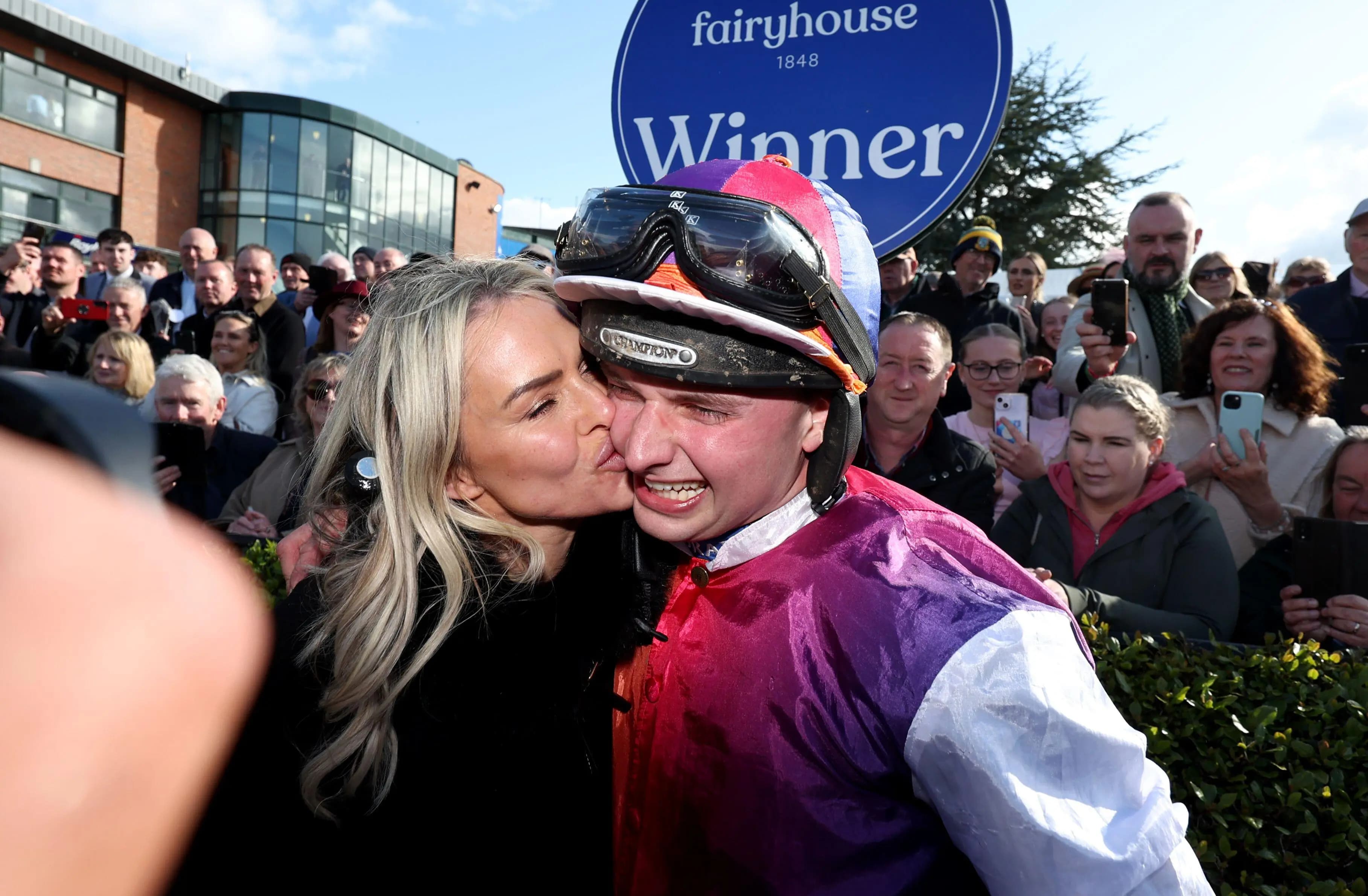 Jockey Sean Bowen is kissed by trainer Rebecca Curtis as they celebrate after their horse Haiti Couleurs won the Irish Grand National.