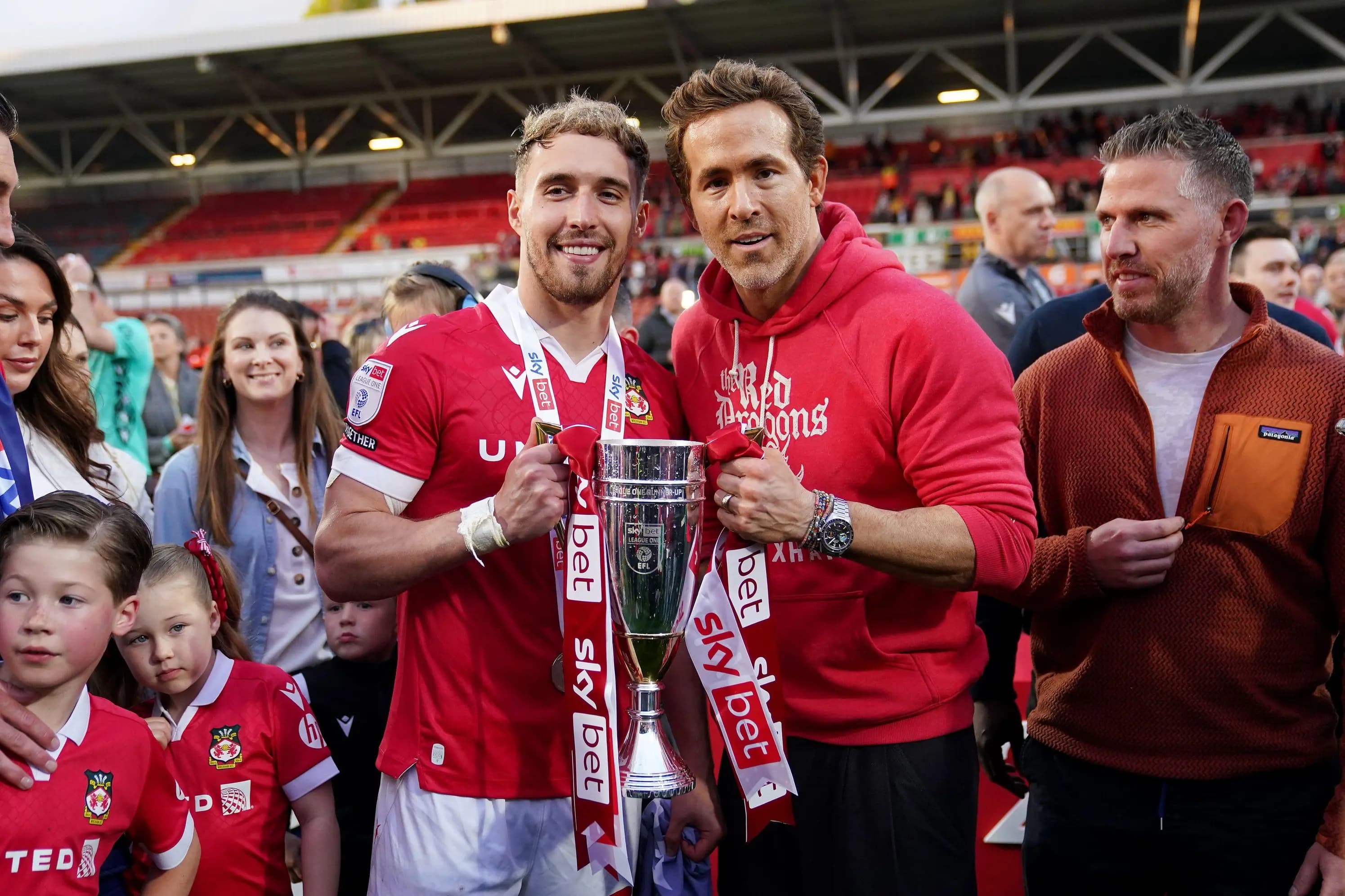 Wrexham co-owner Ryan Reynolds (centre right) and Wrexham's Sam Smith celebratePic. Alamy