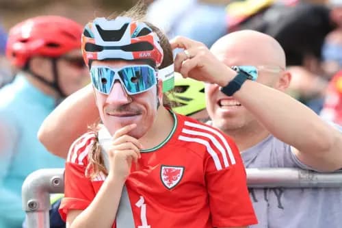 A young Welsh cycling fan dons a Geraint Thomas mask.  Pic: Owen Morgan