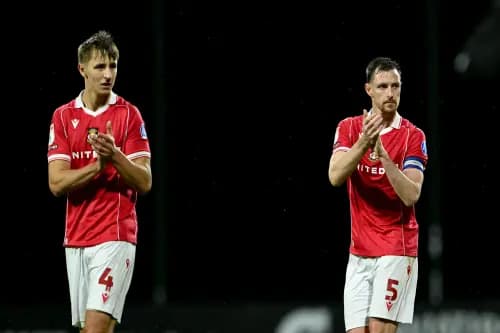 Wrexham's Max Cleworth (left) and Dominic Hyam applaud the fans. Pic: Alamy