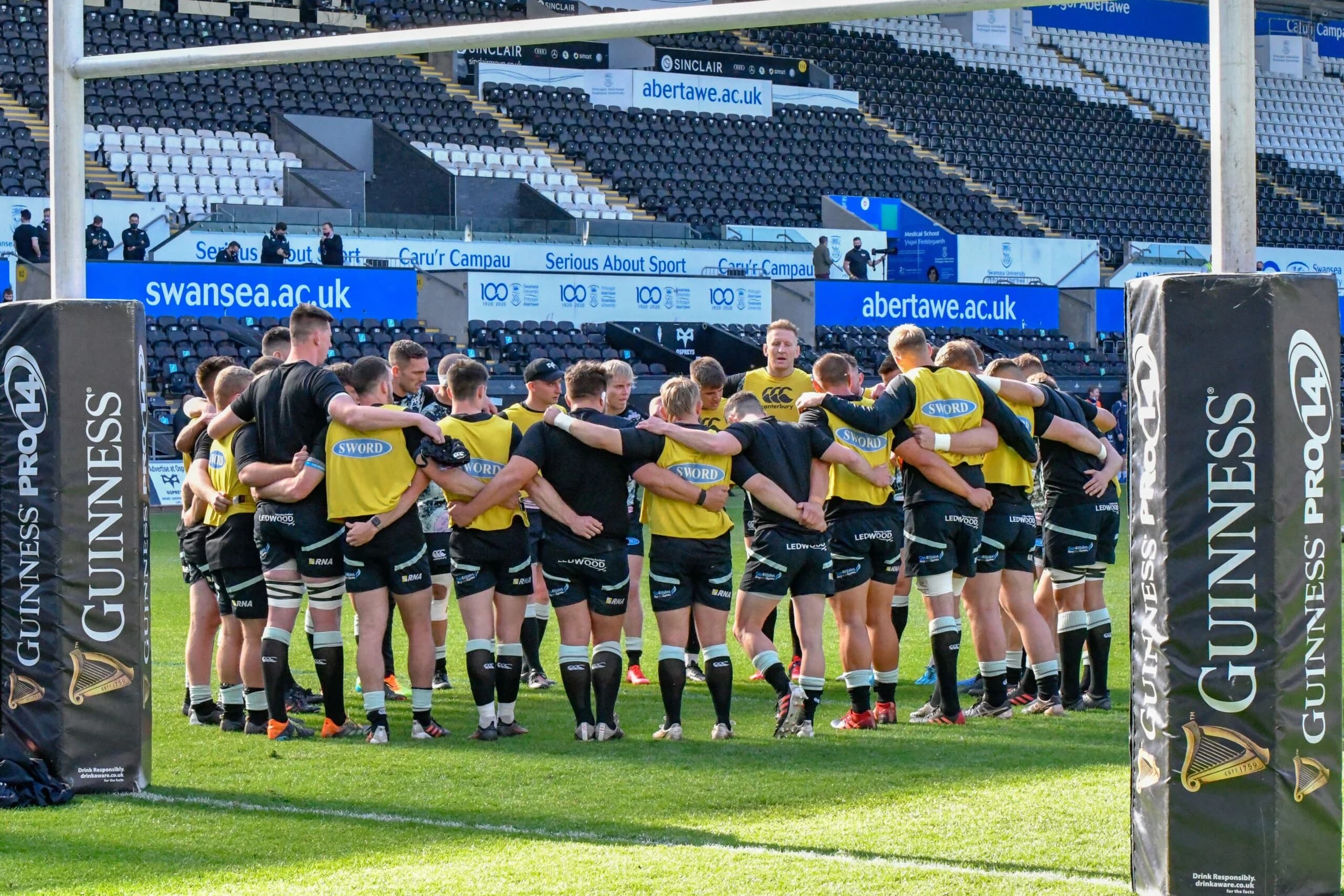 Ospreys players in a pre-match huddle. Pic: Duncan Thomas/Majestic Media/Alamy