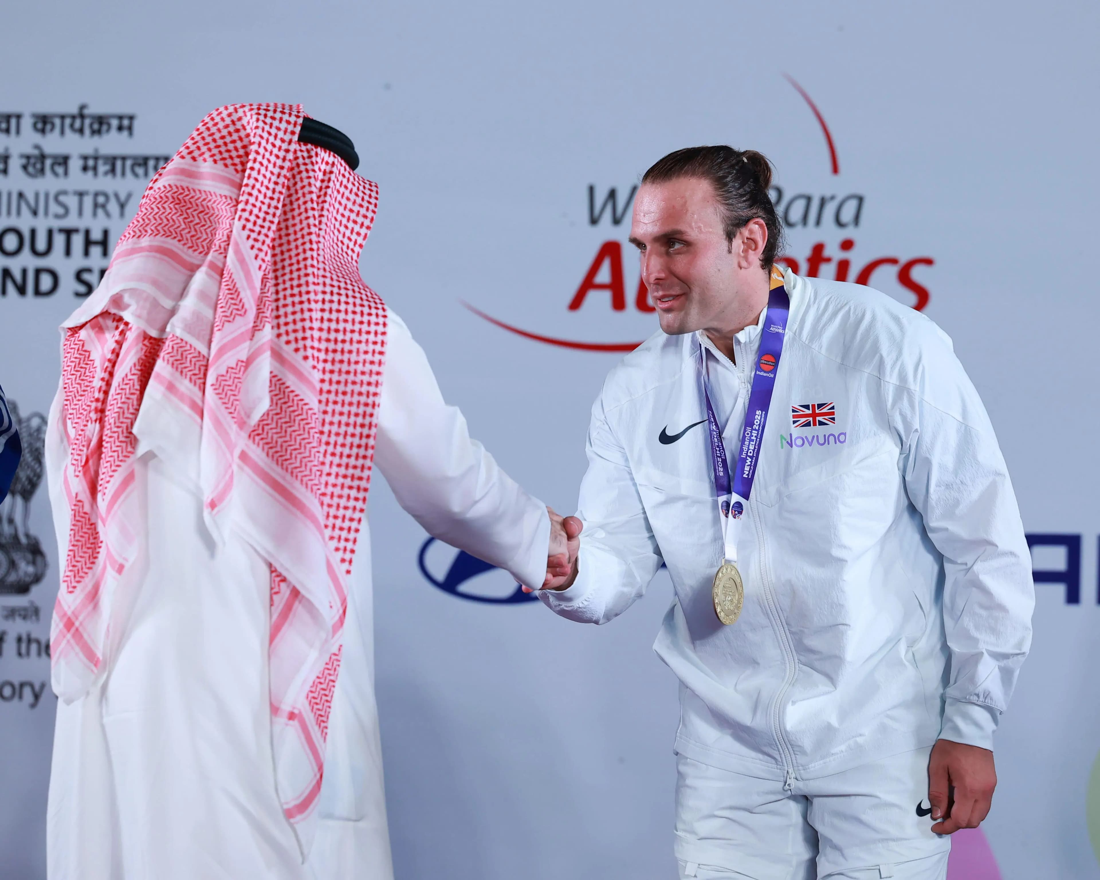 Aled Davies of Great Britain receives his gold medal in New Delhi. Pic Alamy