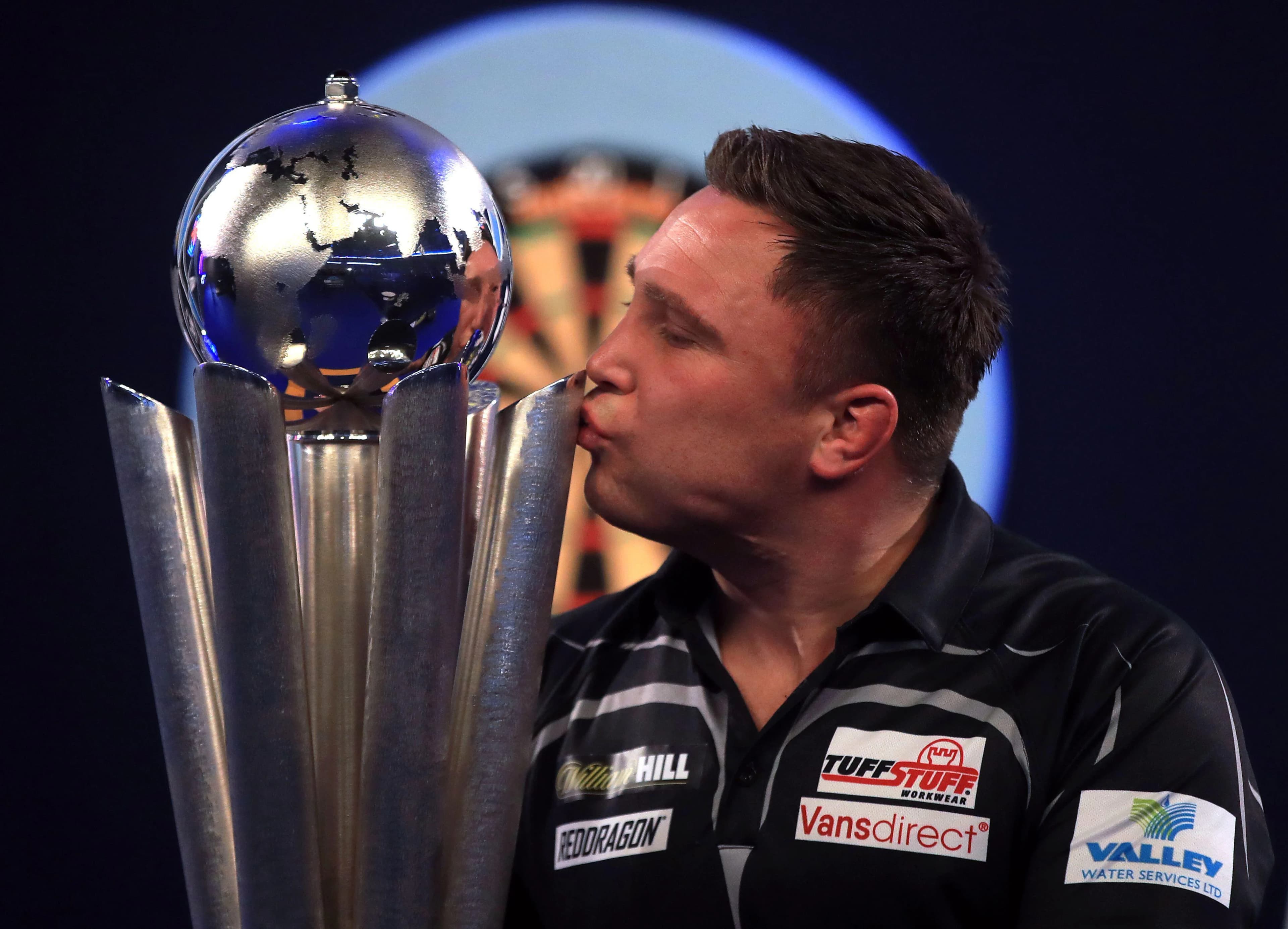 Gerwyn Price kisses his trophy after a win