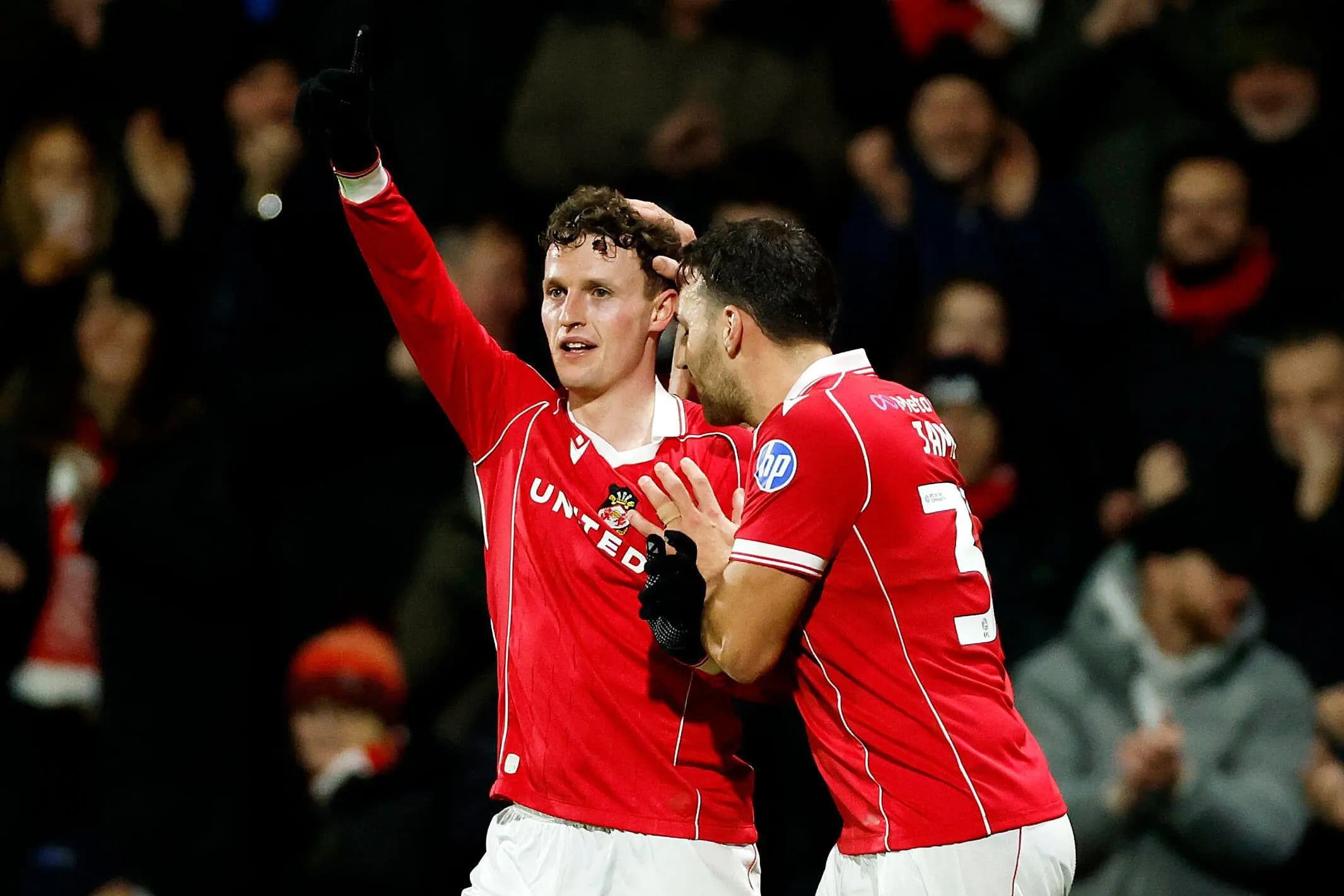 Wrexham's Nathan Broadhead (left) celebrates with team-mates. Pic. Alamy