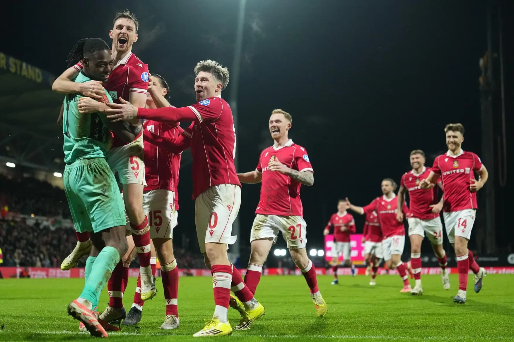 Wrexham goalkeeper Arthur Okonkwo celebrates with teammates. Pic: Alamy.