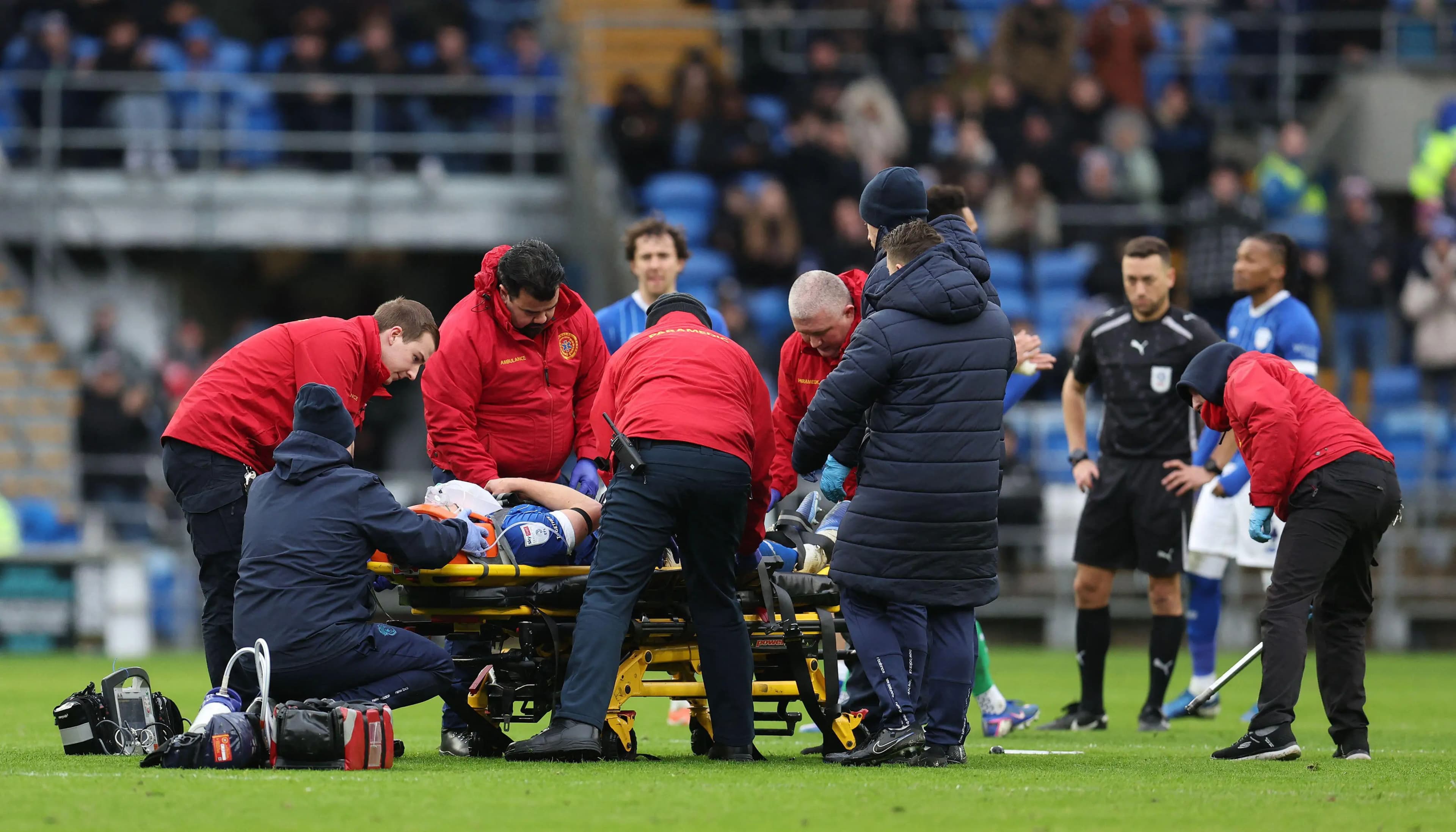 Cardiff City striker Yousef Salech is taken off on a stretcher. Pic: Alamy
