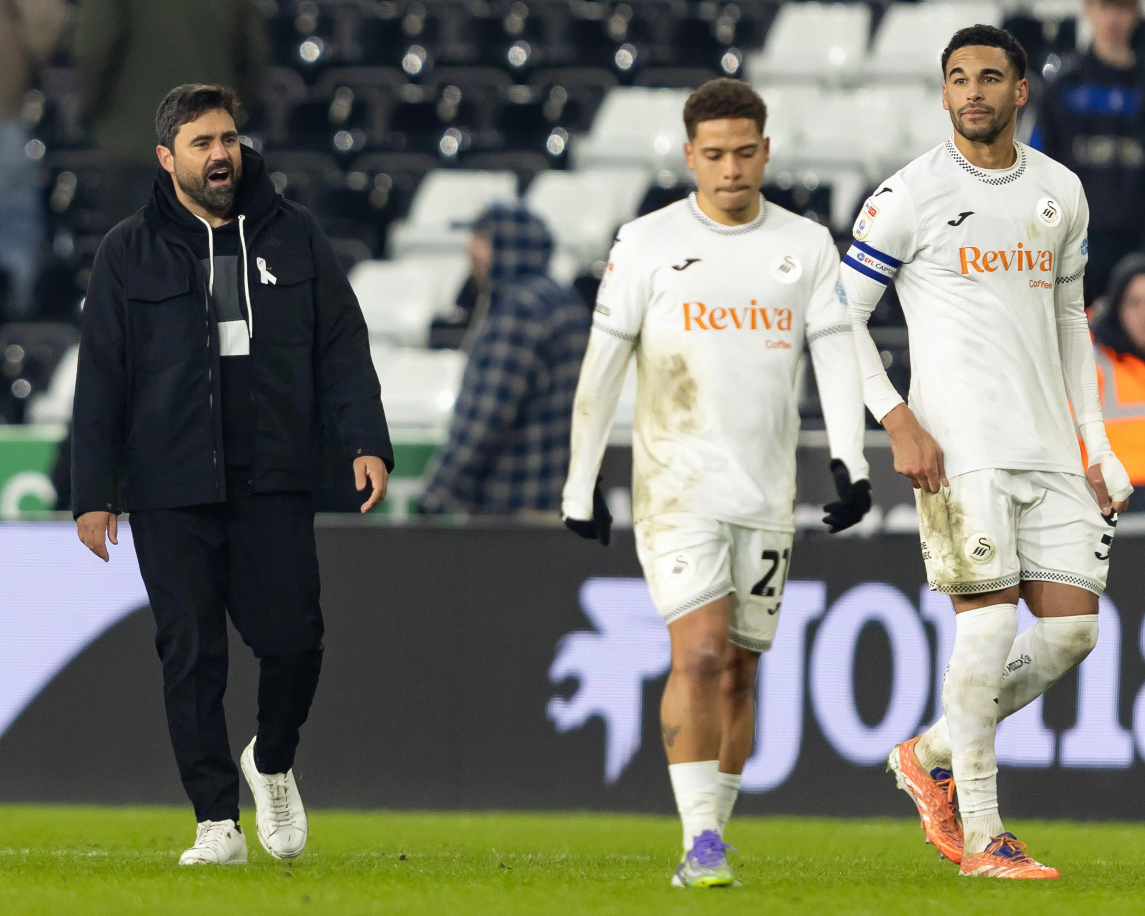 Swansea City head coach Vitor Matos and players Manuel Benson (centre) and Ben Cabango. Pic: Alamy.