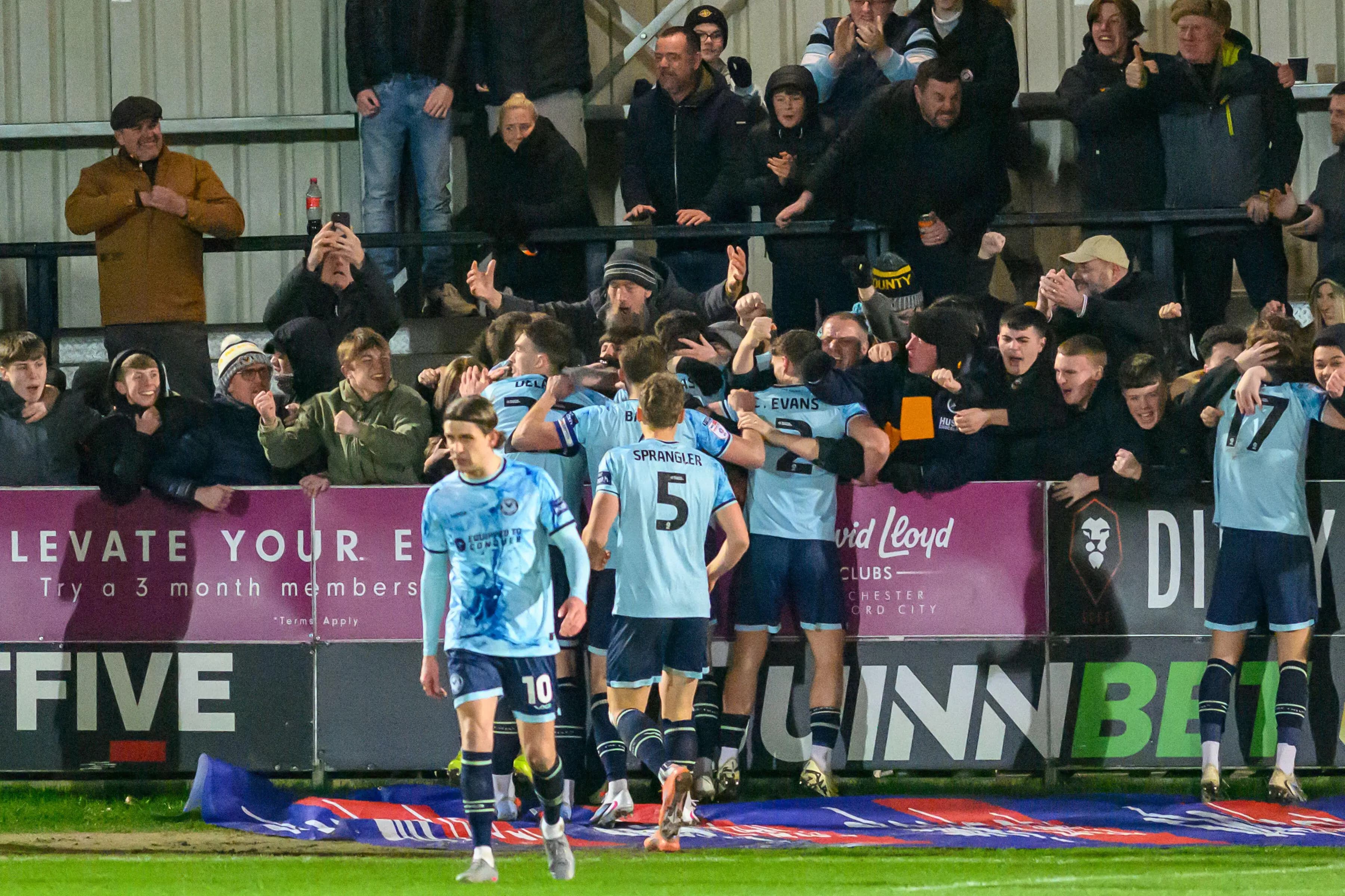 Ben Lloyd of Newport County celebrates scoring his side's second goal with teammates and fans. Pic: Alamy.