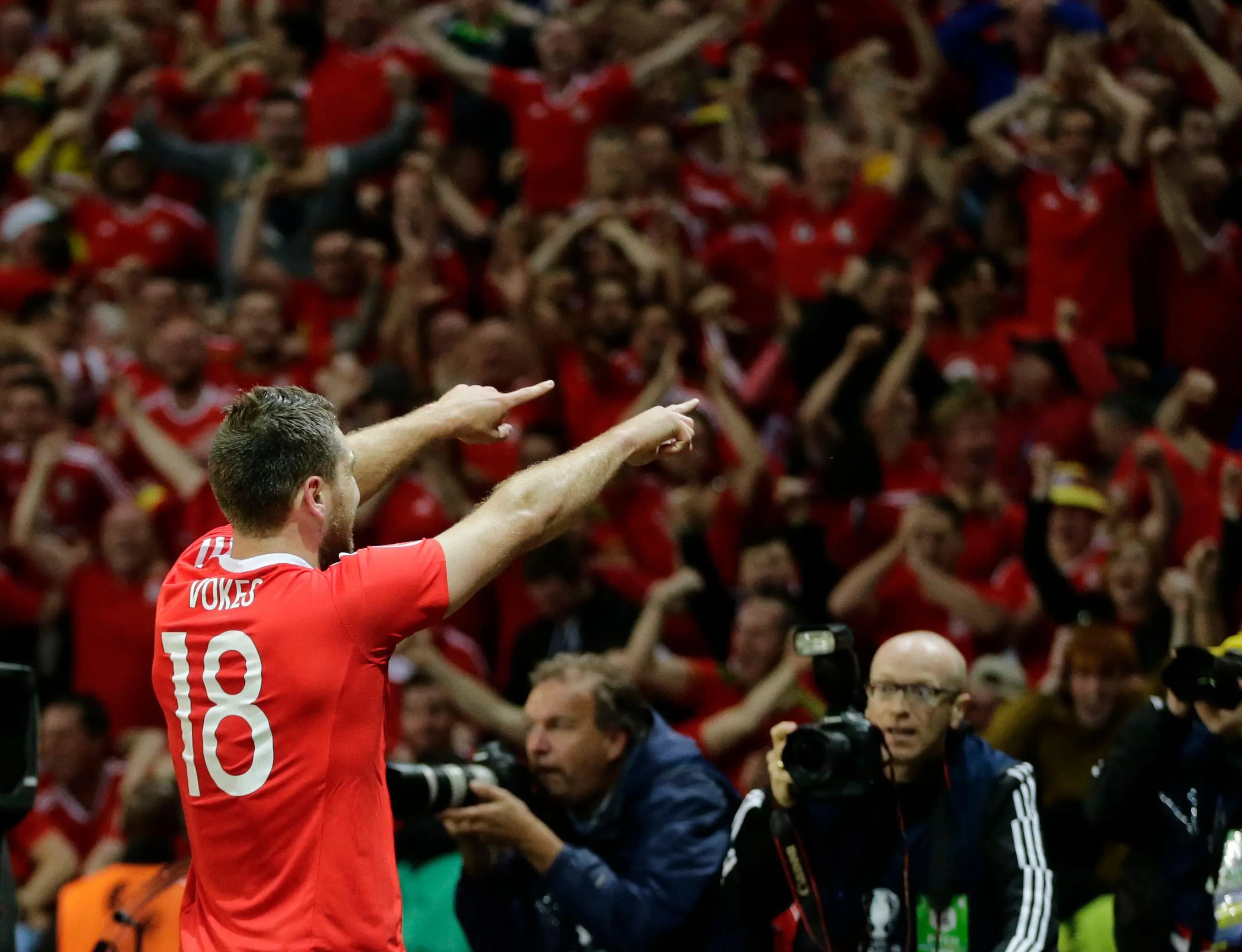Sam Vokes celebrates with Wales fans after his famous goal against Belgium in 2016. Pic: Alamy
