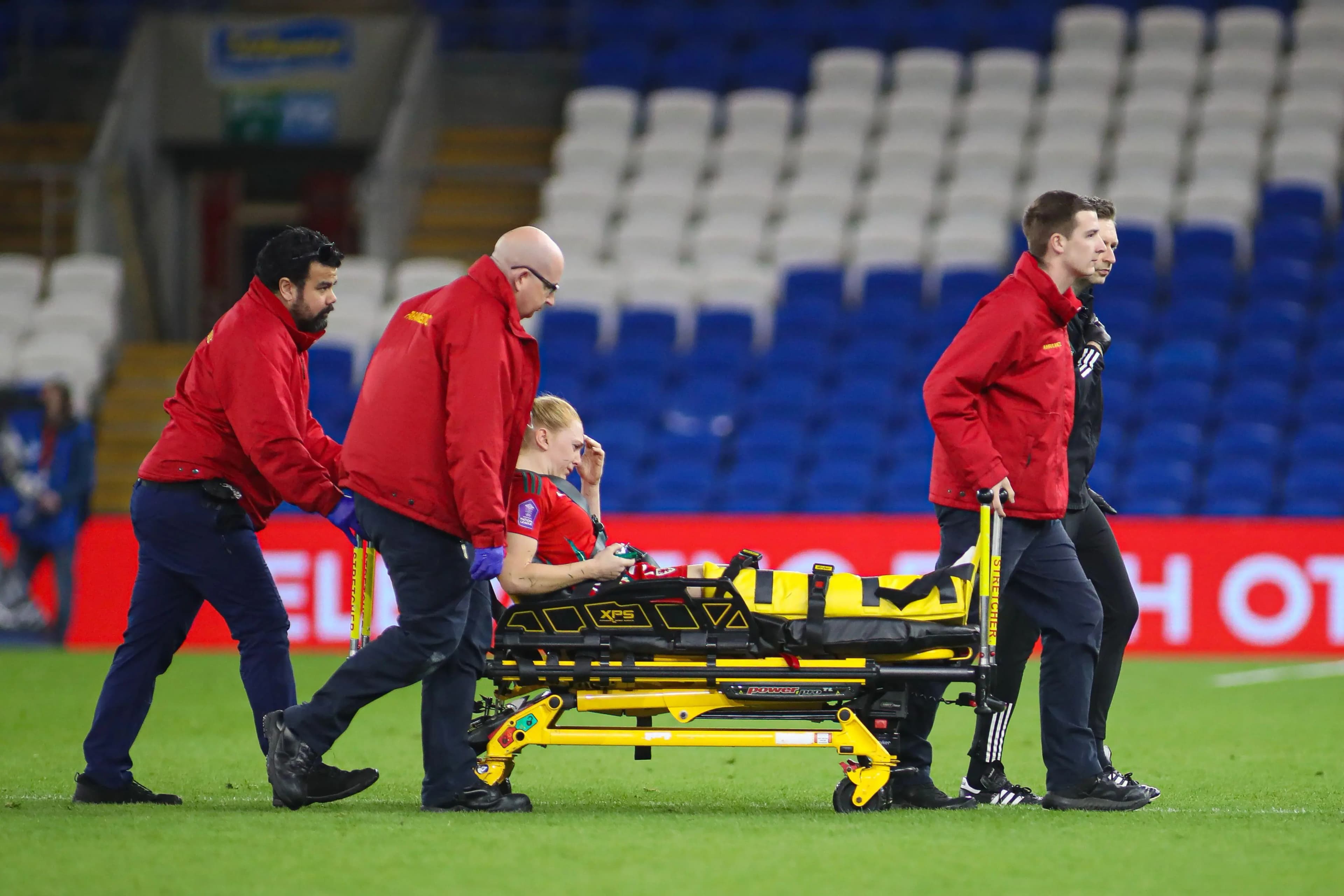 Wales' Ceri Holland is taken off by medics. Pic: Alamy
