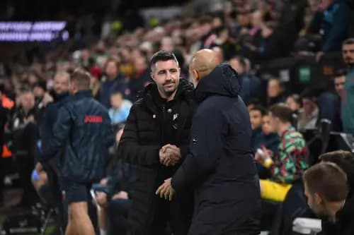 Swansea City head coach Alan Sheehan shakes the hand of Pep Guardiola. Pic: Alamy