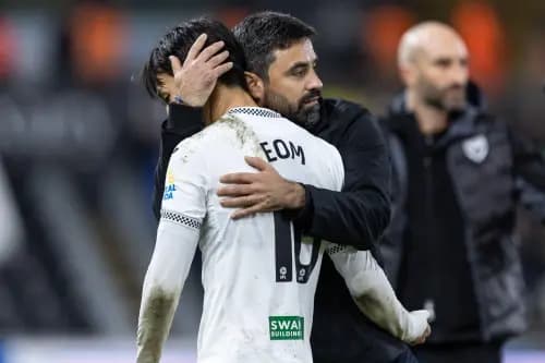 Vitor Matos Manager of Swansea City embraces Ji-Sung Eom of Swansea City. Pic: Alamy