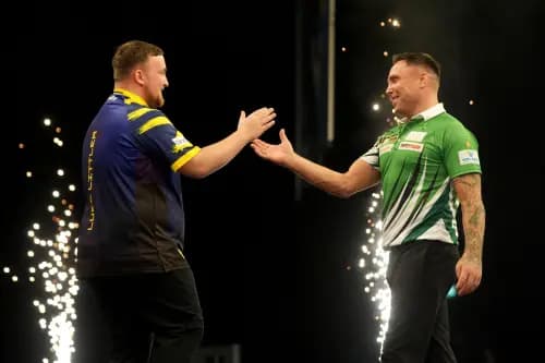Luke Littler (left) shakes hands with Gerwyn Price. Pic. Alamy