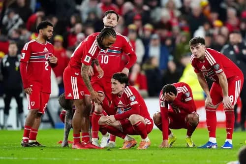 Wales' Harry Wilson (centre) and team-mates react after losing the penalty shoot-out. Pic. Alamy