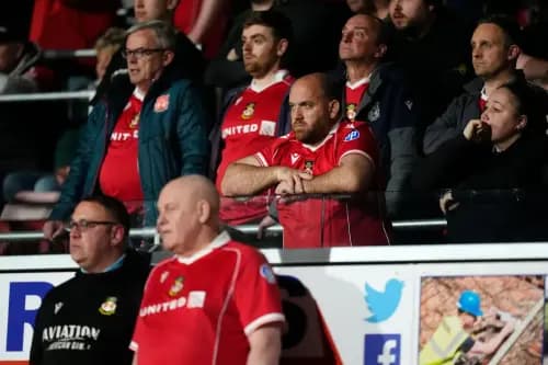 Wrexham fans show their dejection while watching. Pic. Alamy