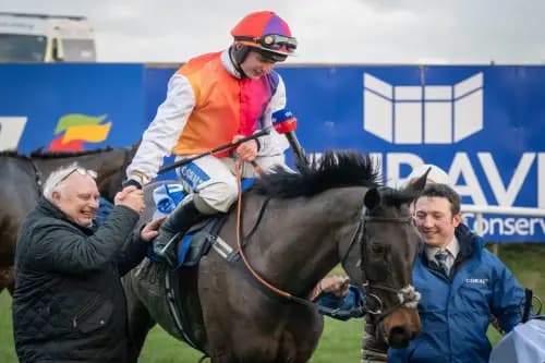 Sean Bowen is congratulated by father Peter Bowen after winning the Coral Welsh Grand National on Haiti Couleurs at Chepstow. Pic: Alamy.