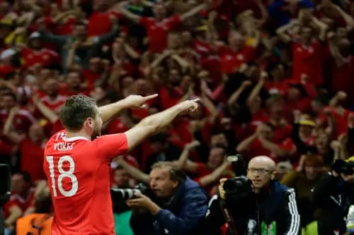 Sam Vokes celebrates with Wales fans after his famous goal against Belgium in 2016. Pic: Alamy